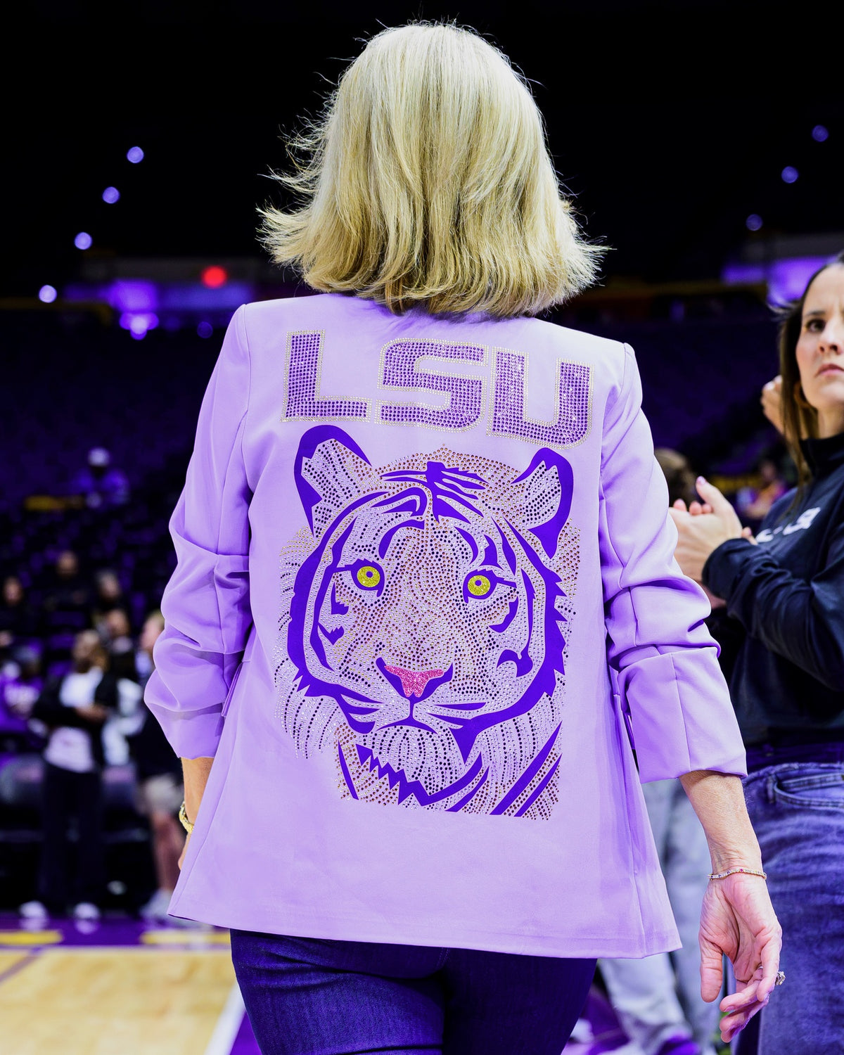 LSU head coach Kim Mulkey wearing the Moving Forward Designs lavender LSU purple tiger rhinestone blazer