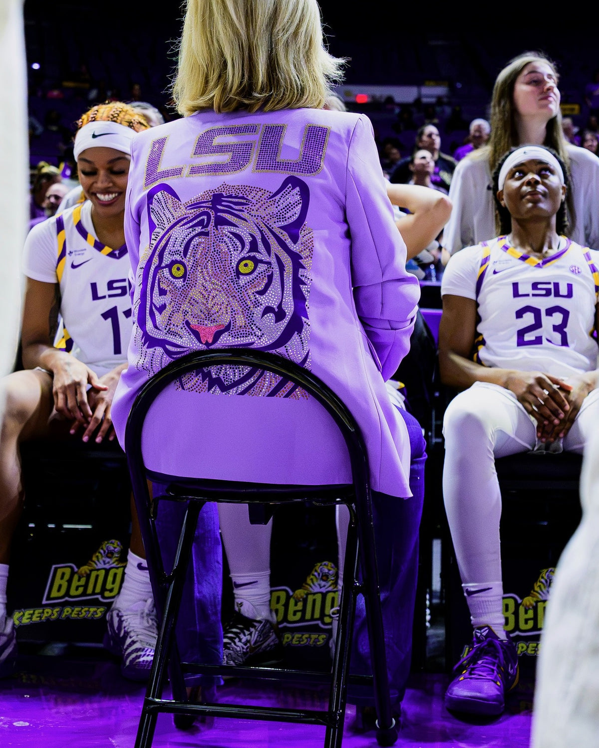 Coach Kim Mulkey with the LSU bench wearing the lavender tiger rhinestone blazer