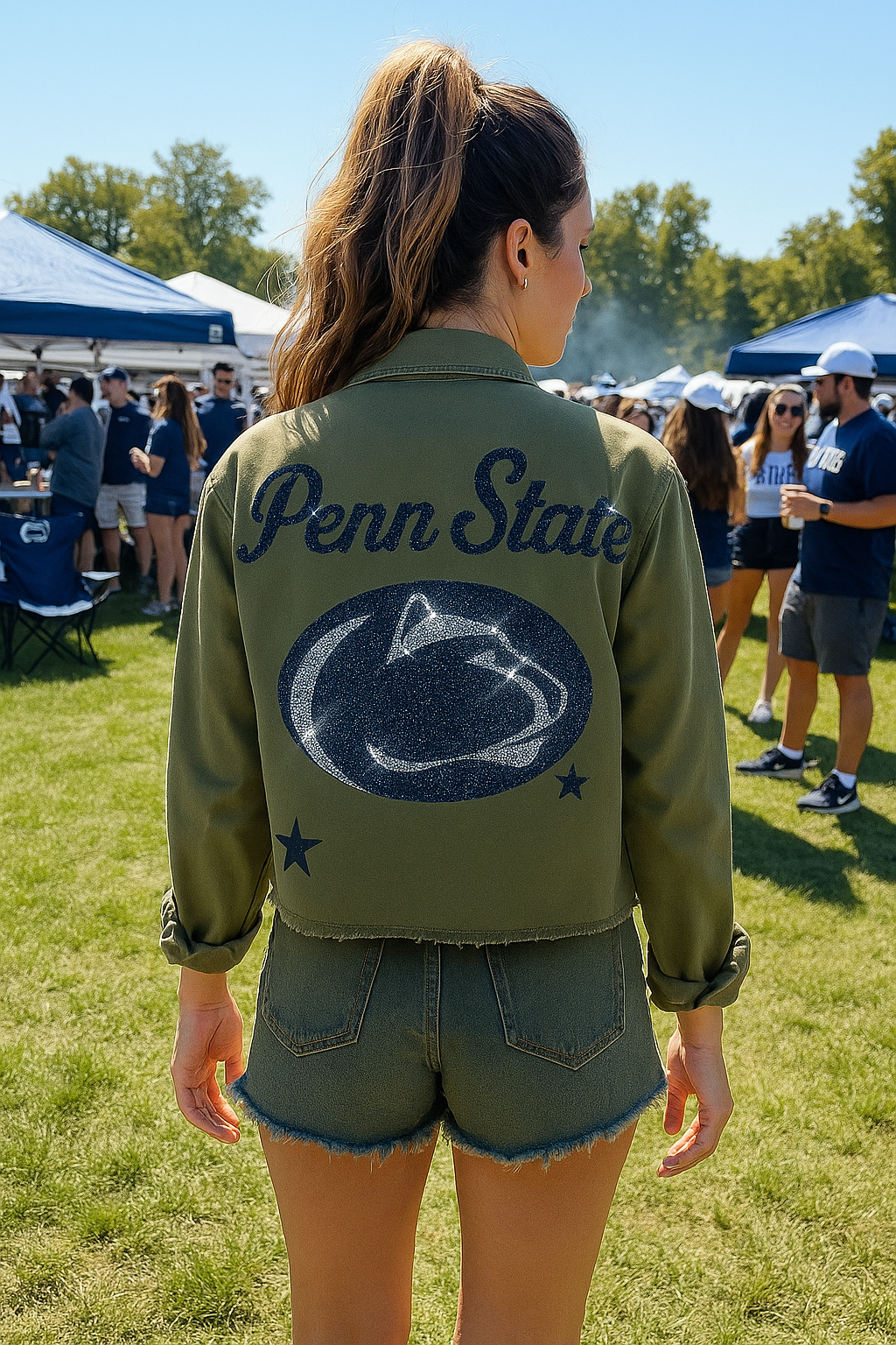 Person wearing a green 'Penn State' jacket with a logo at an outdoor event.